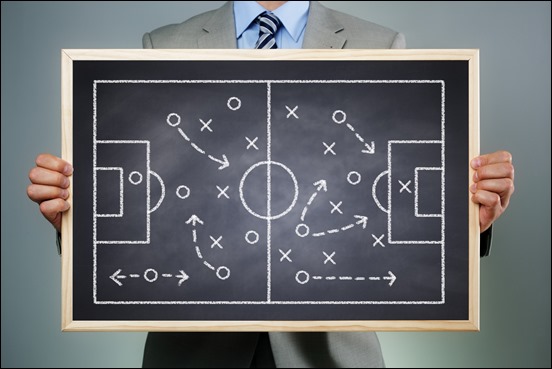 Business strategy businessman holding a blackboard planning team strategy on a chalk drawing of a so